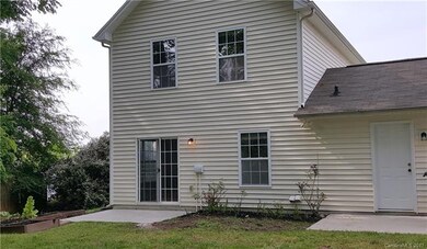 Back of home with two patios.  Planting areas
