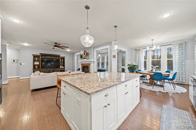 Kitchen with pendant lighting, a fireplace, ceilin