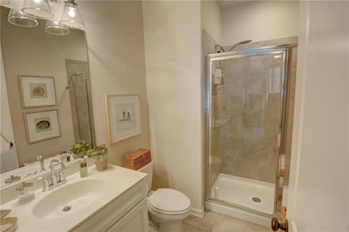 Full bath featuring toilet, tile patterned floors,