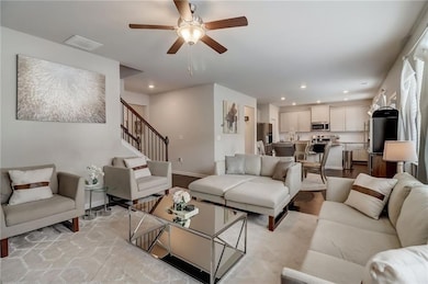 Living room featuring ceiling fan and light hardwood / wood-style floors