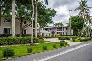 View of home's community featuring a yard