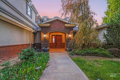 Property entrance with brick siding, stucco siding, and a lawn