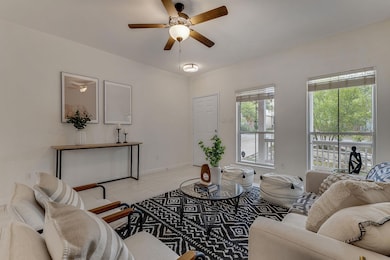 Step inside and the space instantly feels calm and collected — airy white walls, layered textures, and natural light flowing in through oversized windows.