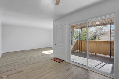 Empty room featuring light wood-style flooring and ceiling fan