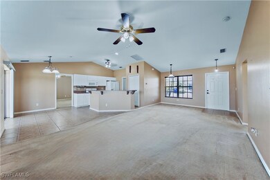 Unfurnished living room featuring a ceiling fan, l