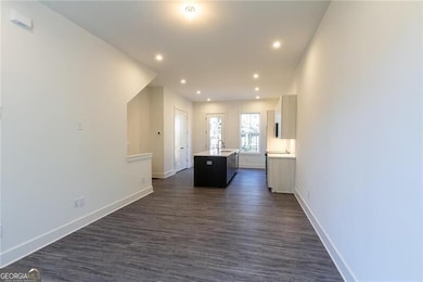 Hall featuring baseboards, recessed lighting, and dark wood-type flooring