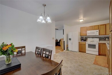 Kitchen with pendant lighting, a chandelier, white