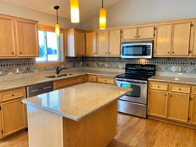 Spacious kitchen with granite counter tops, tile b