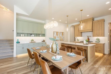 Dining space featuring stairway, a chandelier, light wood-style flooring, and recessed lighting