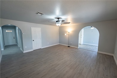 Living Room featuring arched walkways, a ceiling f