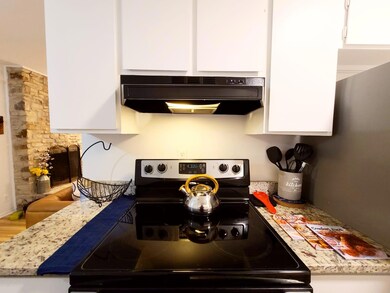 Kitchen featuring under cabinet range hood, elect