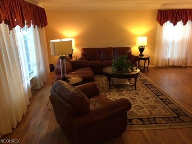 SPACIOUS SUNLITE LIVING ROOM WITH CROWN MOLDING, F