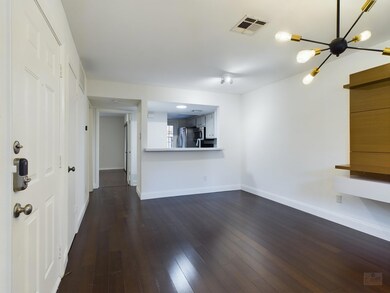 Unfurnished living room with baseboards, dark woo