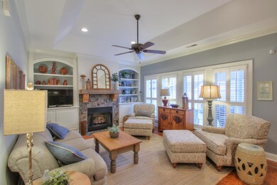 Gather your friends and family in the bright living room, complete with built ins and gas fireplace with logs. Plantation shutters are throughout the cottage.