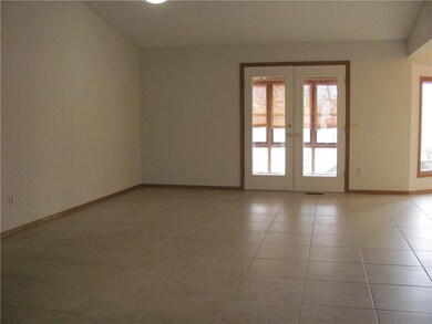 Large open living area with access to enclosed back porch.