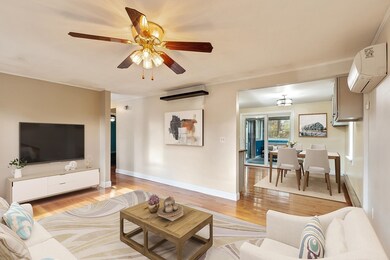 Living Room w Kitchen and Sunroom Beyond (virtually staged)
