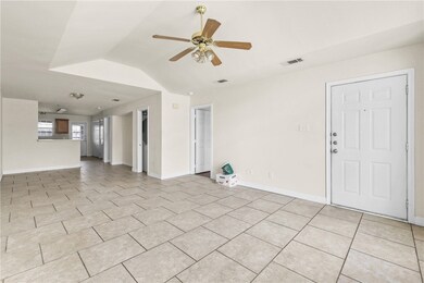 Unfurnished living room featuring ceiling fan, lof