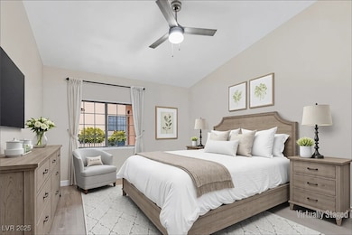 Bedroom with light wood-type flooring, lofted ceil