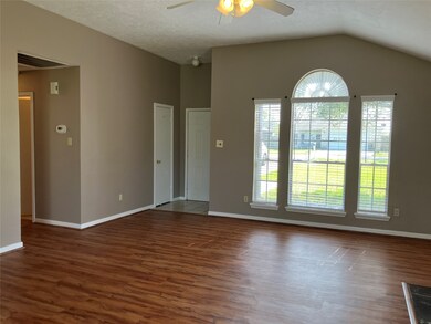 Another view of the living room with hallway leadi