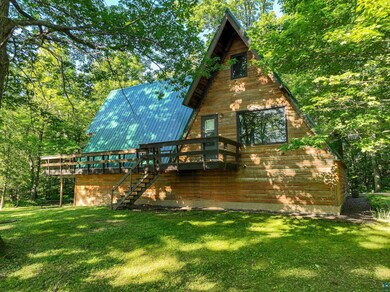 Back of house featuring a yard and a deck