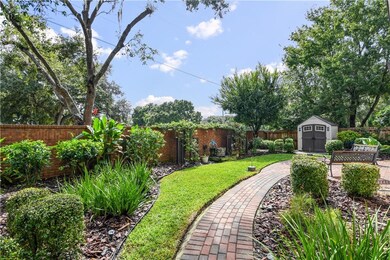 View across back yard with pathway to fence gate a
