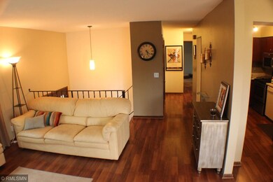 Living Room with stairs shown with the railing. Ha