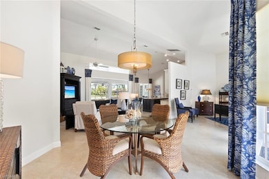 Dining room featuring a ceiling fan, high vaulted ceiling, light tile patterned flooring, and baseboards
