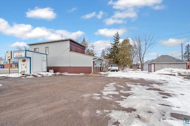 View of snowy exterior with an outbuilding