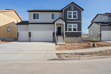 View of front of property with concrete driveway, an attached garage, and board and batten siding