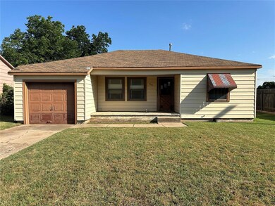 View of front of property featuring a garage and a