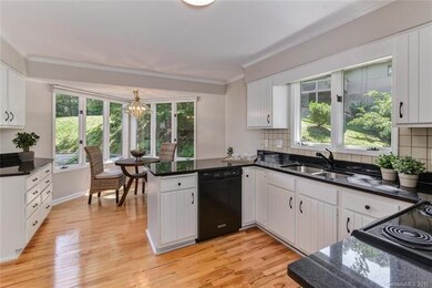 Loads of counter space, cabinetry, and windows in 