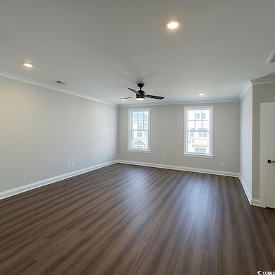 Spare room with dark wood-type flooring, ornamental molding, recessed lighting, and a ceiling fan