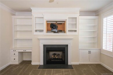 Gas fireplace with built-in shelving and desk area