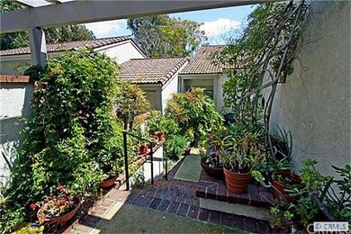 Front courtyard filled with flowers.
