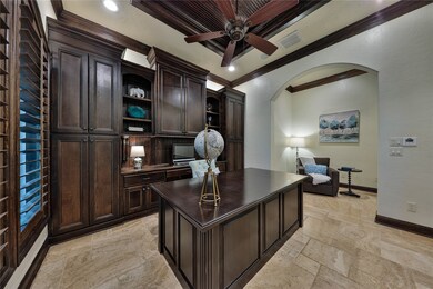 Stately details of masculine woodwork and a rich paneled ceiling inlay punctuate the warmth and beauty of the stunning sun-lit study.
