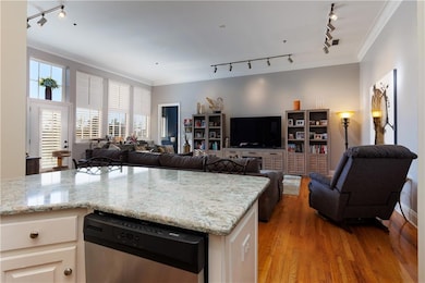 Kitchen with light stone counters, stainless steel