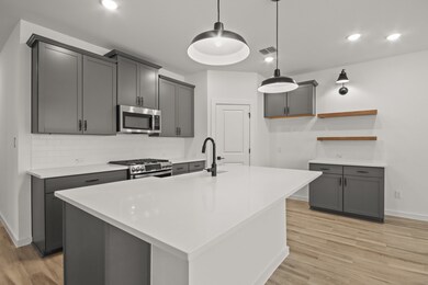 Lovely kitchen with grey cabinets and quartz count