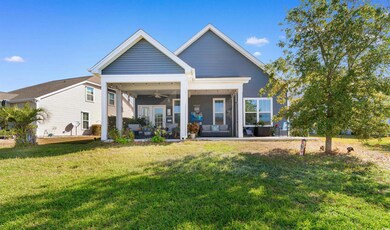 Back of house featuring screen porch, ceiling fan 