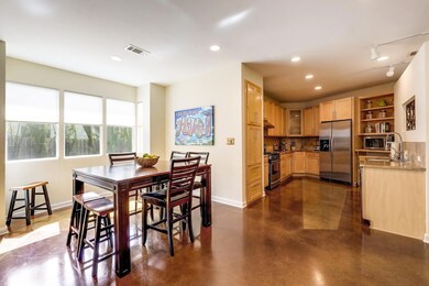 Dining space with concrete flooring, recessed lig