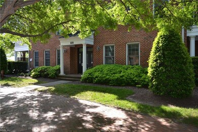 Lush plantings frame this brick exterior