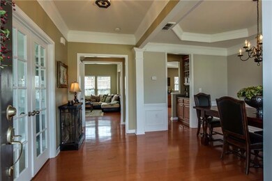 Separate office on left has doors for privacy, formal dining connects to butlers pantry off the kitchen, gorgeous hardwood floors throughout main level