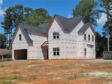 Property in mid-construction with a shingled roof