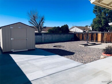View of yard with a patio and a shed