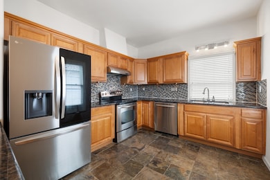 A lovely glass backsplash is illuminated from larg