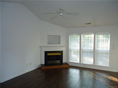 living room with fireplace and ceiling fan