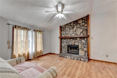 Living room featuring a ceiling fan, wood finished