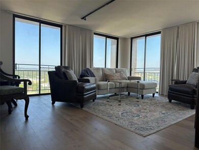 Living area with floor to ceiling windows and wood finished floors