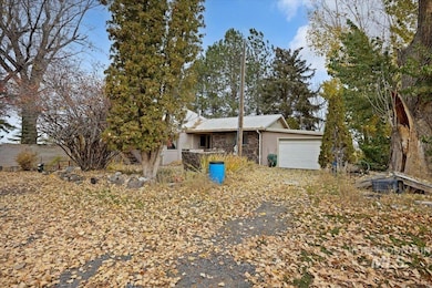 Single story home featuring stone siding and a garage