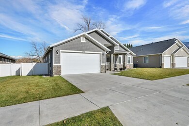 Craftsman-style home with stone siding, concrete driveway, and an attached garage