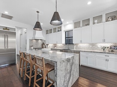 Modern kitchen with stainless steel appliances, wo